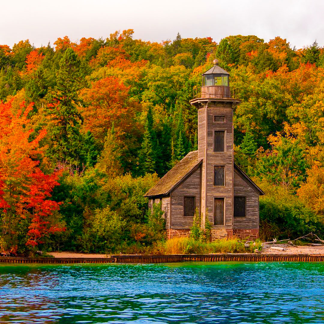 East Channel Lighthouse as seen from a Pictured Rocks Cruise during autumn. PC: @colerobertfisher