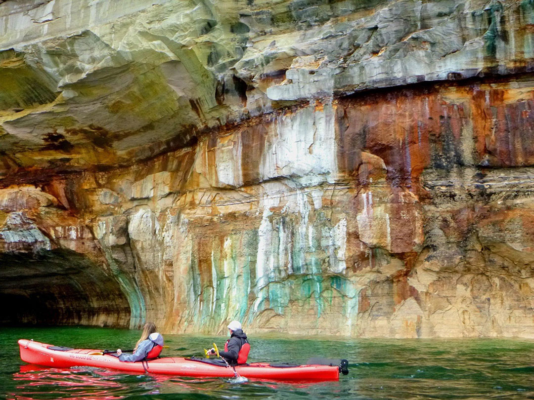 Paddlers get so close they can touch the Pictured Rocks. PC: Pictured Rocks Kayaking. Paddlers get so close they can touch the Pictured Rocks. PC: Pictured Rocks Kayaking.