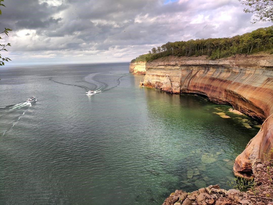 Two Pictured Rocks Cruises boats are seen along the shoreline on a hiking trail. PC: Instagram user @pictured_rocks Two Pictured Rocks Cruises boats are seen along the shoreline on a hiking trail. PC: Instagram user @pictured_rocks