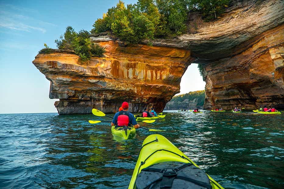 Kayakers paddle near and under Lovers’ Leap. Photo courtesy of Pictured Rocks Kayaking.