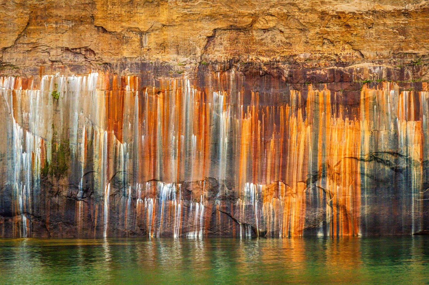 Streaks of mineral-stain color the cliffs of the Pictured Rocks
