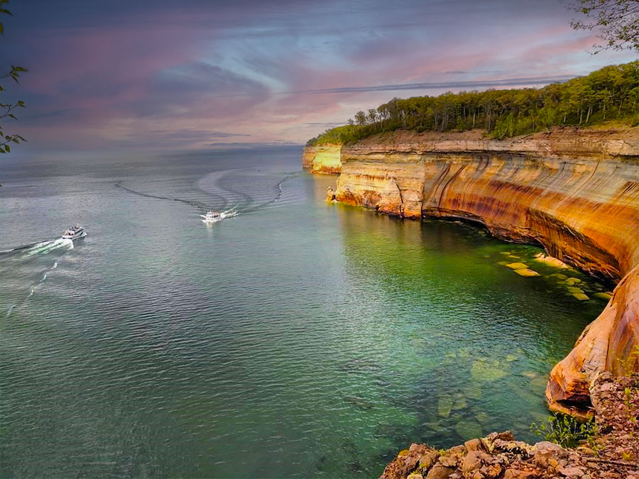 Two Pictured Rocks Cruises boats are seen along the shoreline on a hiking trail. PC: Instagram user @pictured_rocks