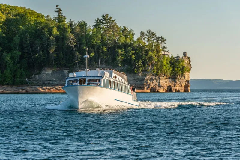 A Pictured Rocks Cruises boat passing by Miners Castle
