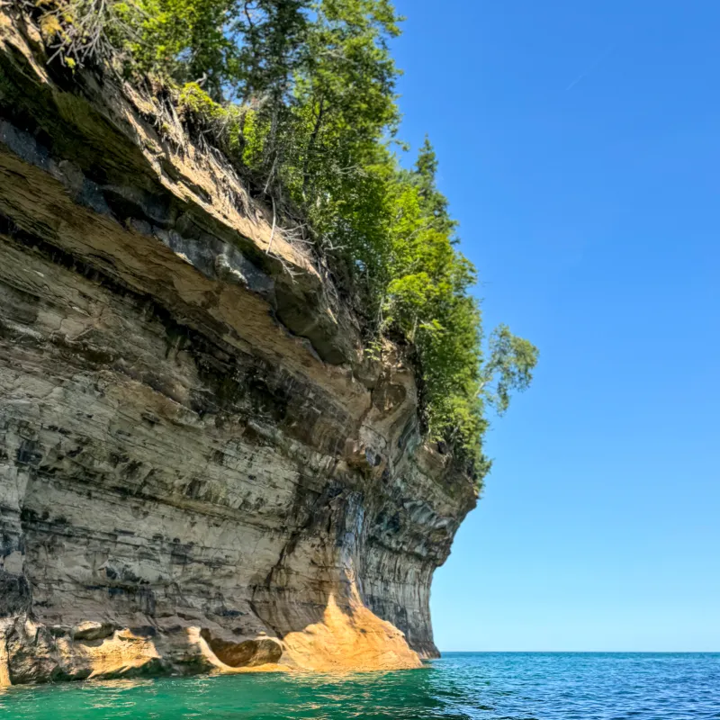 Chapel Cove: Scenic cove with sandstone cliffs, perfect for photography on Pictured Rocks cruises.