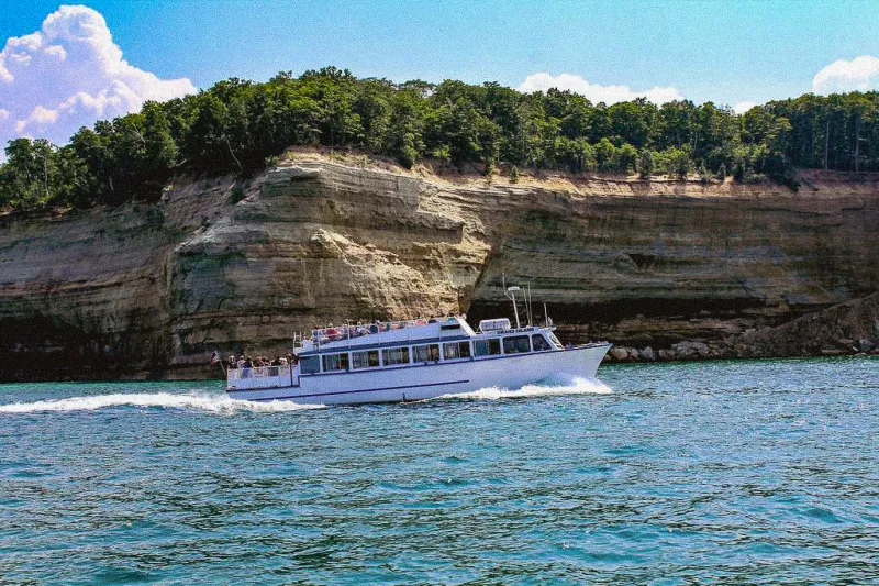 Grand Island Boat in front of cliffs