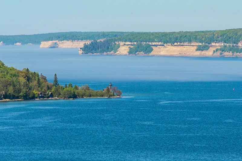 An aerial photo of Grand Island with Pictured Rocks National Lakeshore in the distance