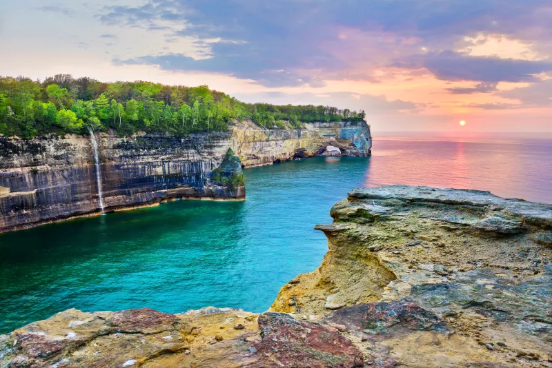 Grand Portal during a sunset in Pictured Rocks, with the sky a beautiful palette of pink and purple
