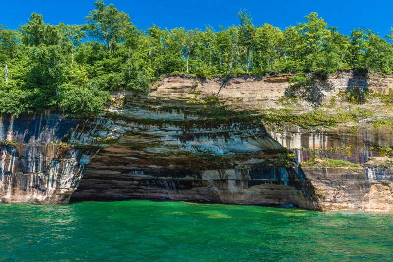 The multicolored mineral streaks of Rainbow Cave