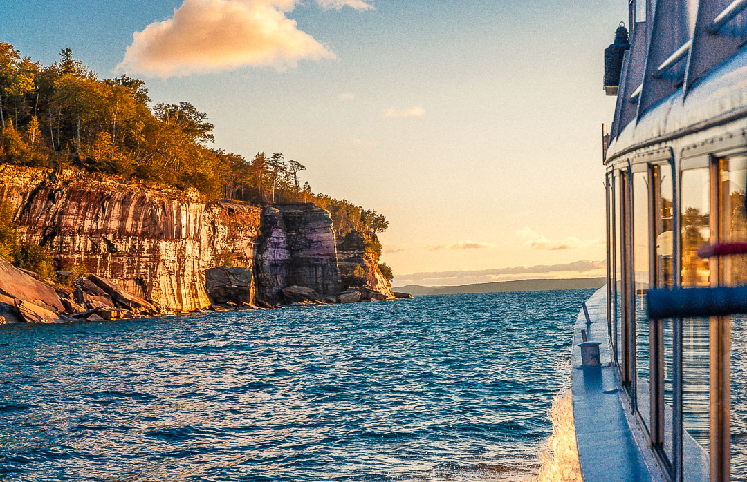 late afternoon Pictured Rocks cruise with sunlit mineral-stained cliffs in the background