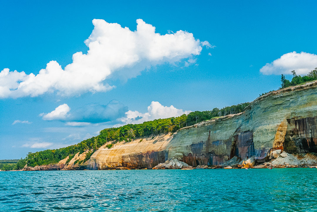 mineral-stained sandstone cliffs of Pictured Rocks National Lakeshore viewed from a boat tour