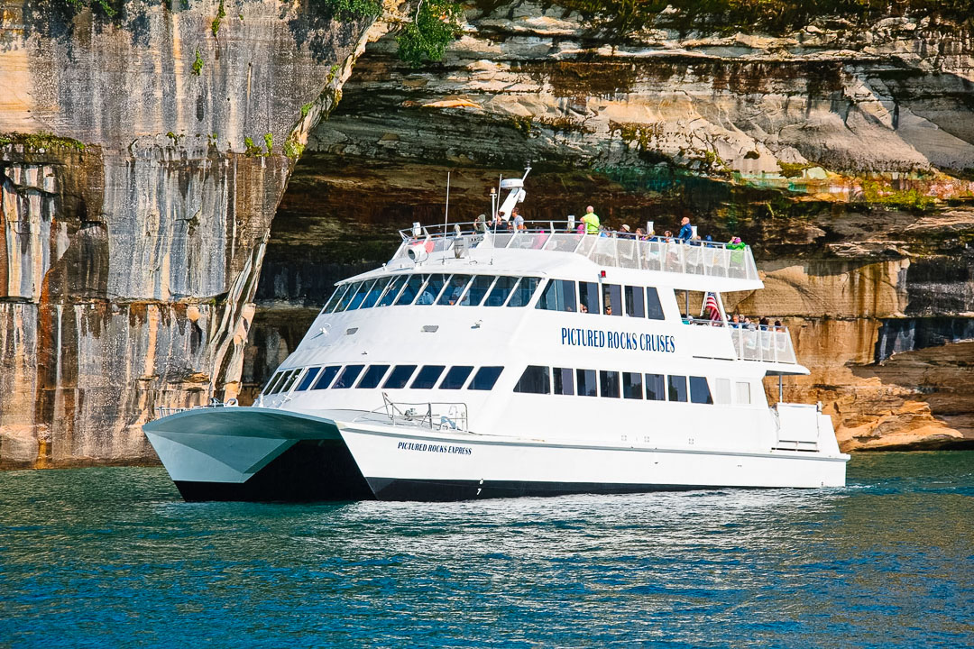 Pictured Rocks Cruises catamaran boat tour in front of Rainbow Cave