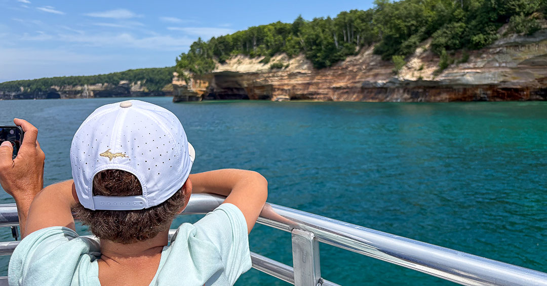young boy watching Lovers Leap from the top deck of a Pictured Rocks cruise