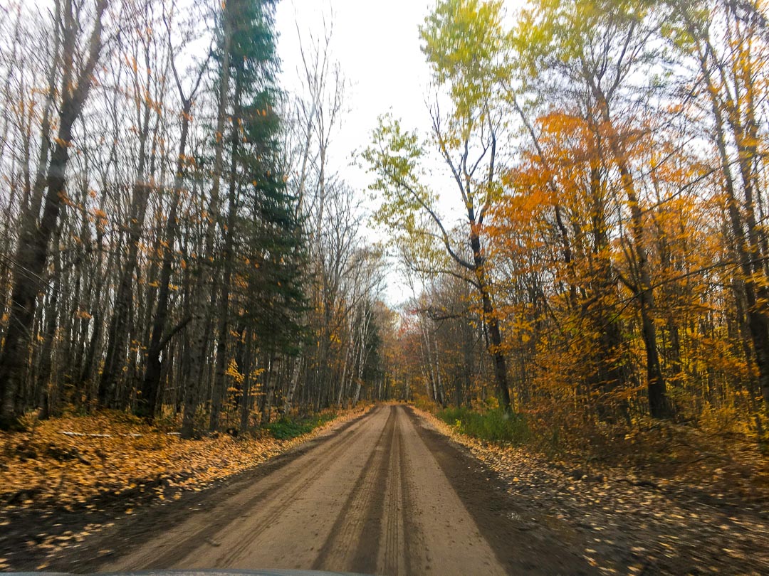 Driving through Pictured Rocks National Lakeshore on a dirt road